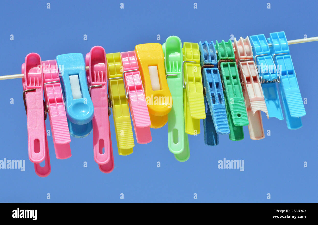 Background of colored clothespins on wire Stock Photo