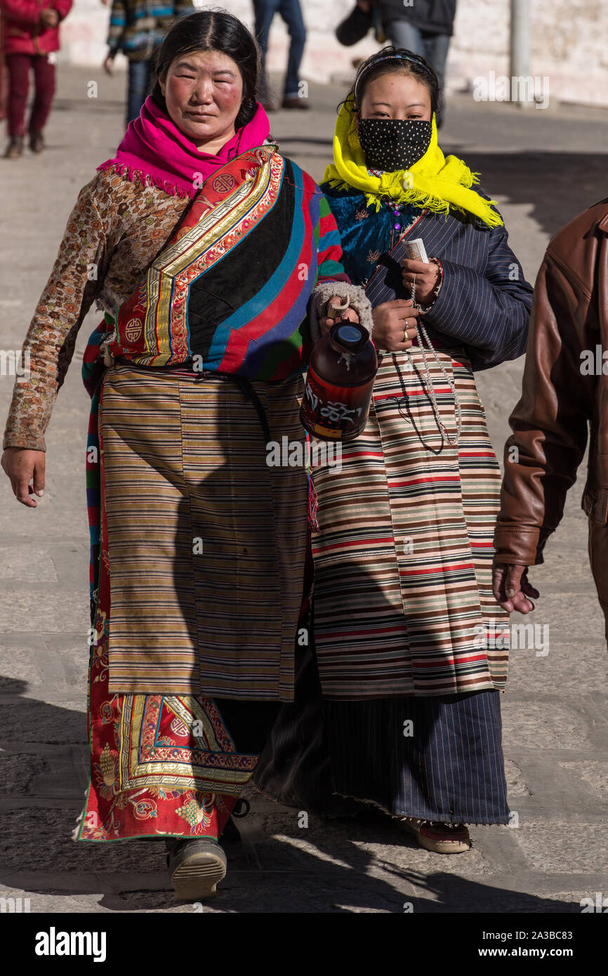 Two Tibetan women pilgrims in traditional dress, including their