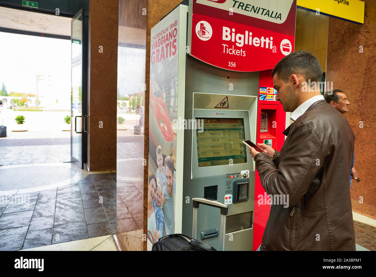 VERONA, ITALY - CIRCA MAY, 2019: man use Trenitalia self-service kiosk at  Verona Porta Nuova Railway Station Stock Photo - Alamy