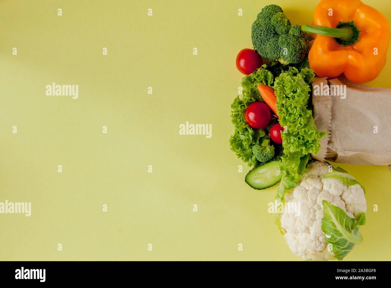 Organic vegetables broccoli cucumbers bell peppers apples in brown