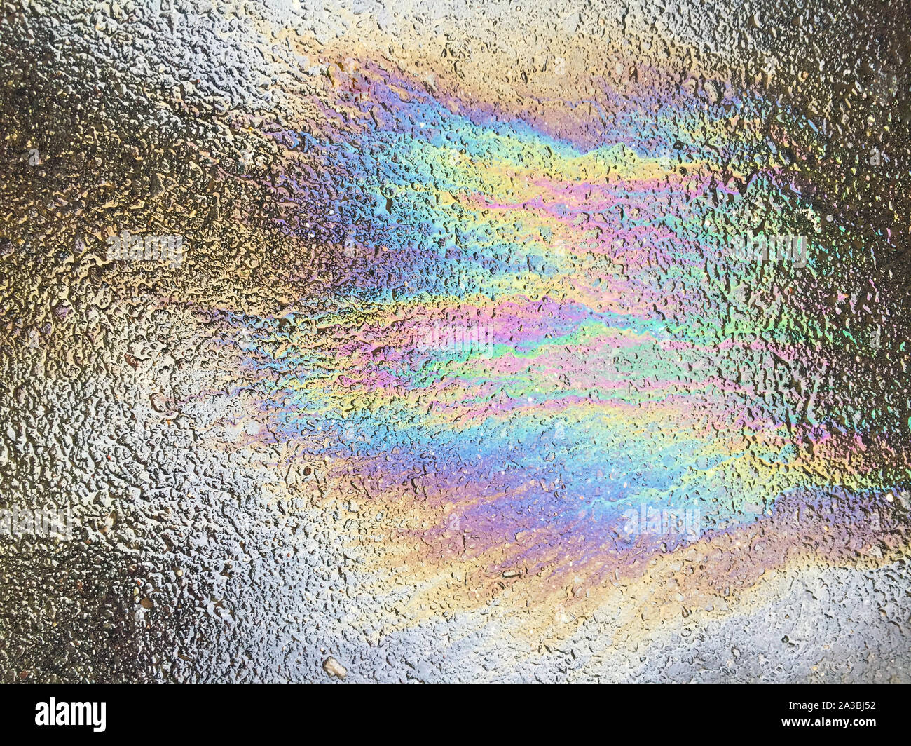 Oil spill pattern on asphalt Stock Photo