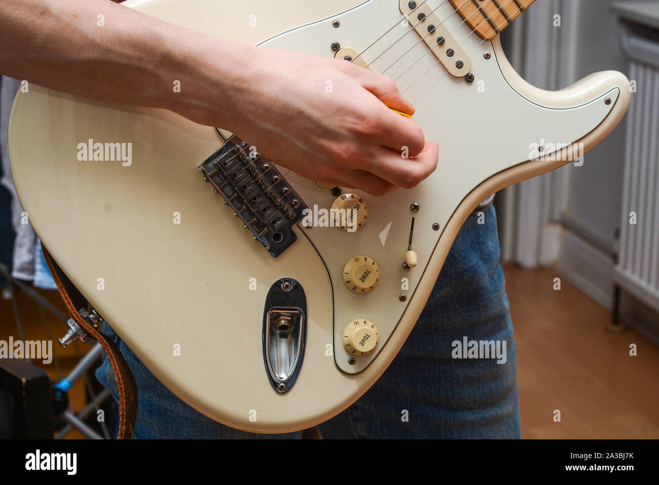 Guy playing at Fender Stratocaster electric guitar Stock Photo