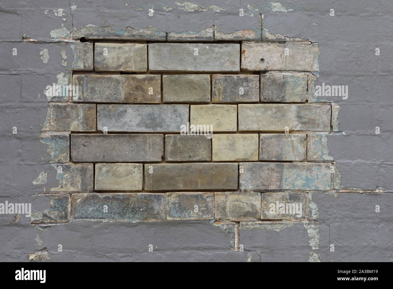 exposed bricks on a grey painted wall Stock Photo Alamy