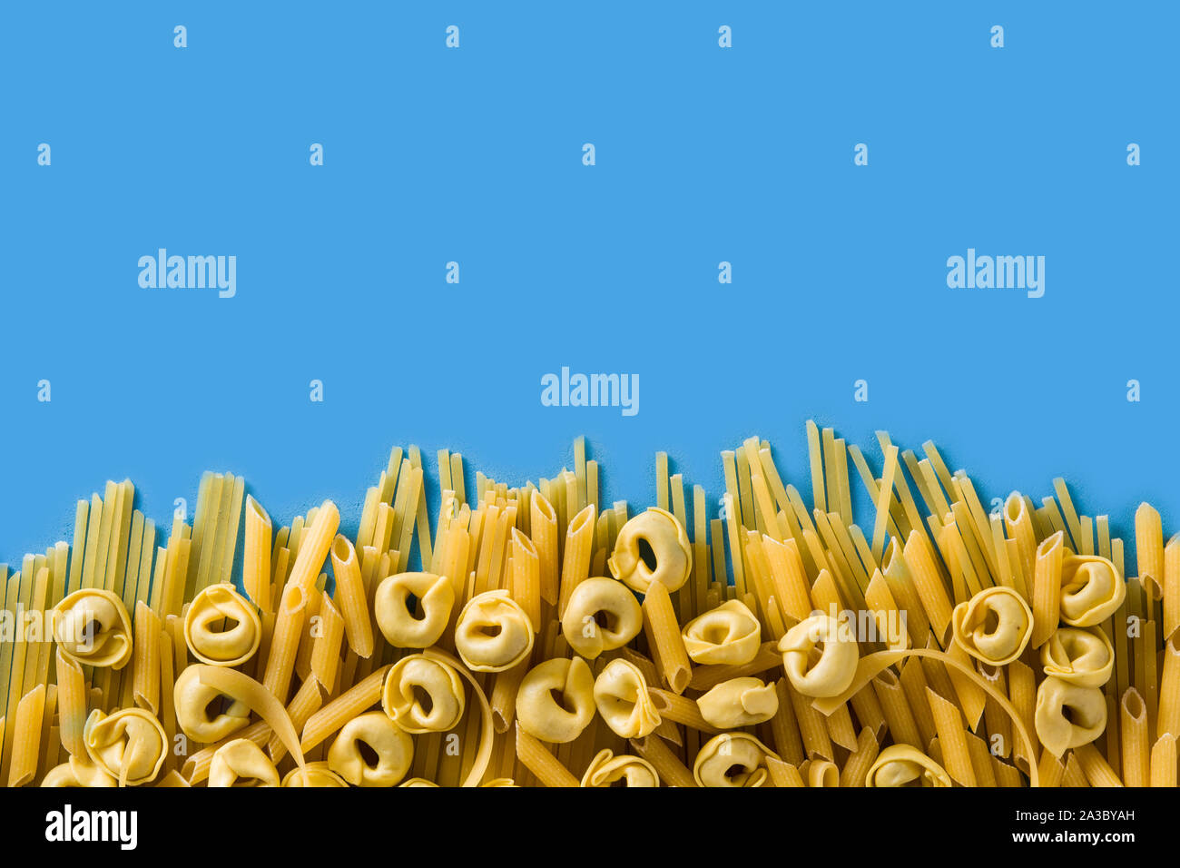 Different types of pasta. Ravioli, penne pasta, tortellini and