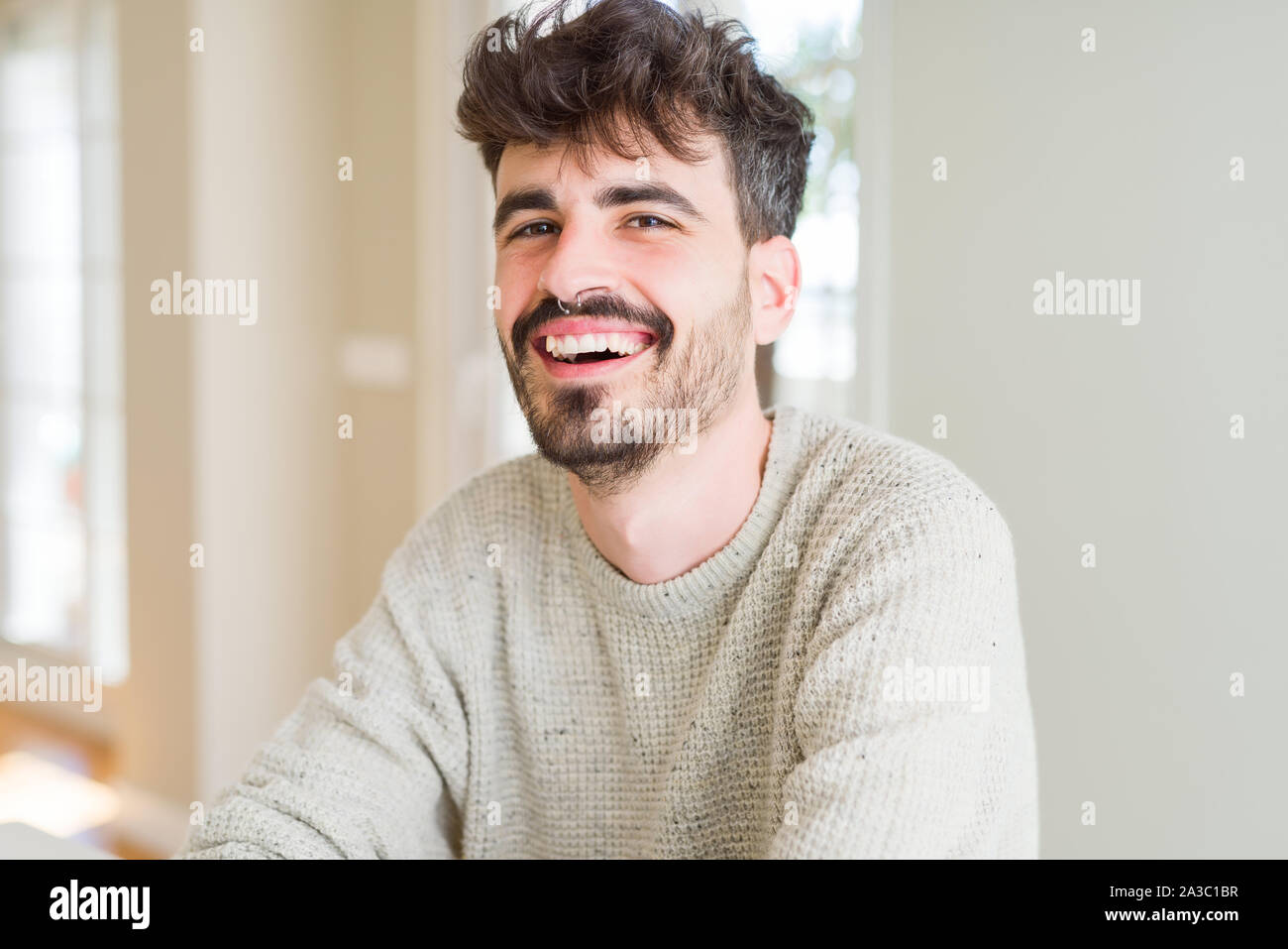 Handsome young man smiling cheerful at the camera with a big smile on ...
