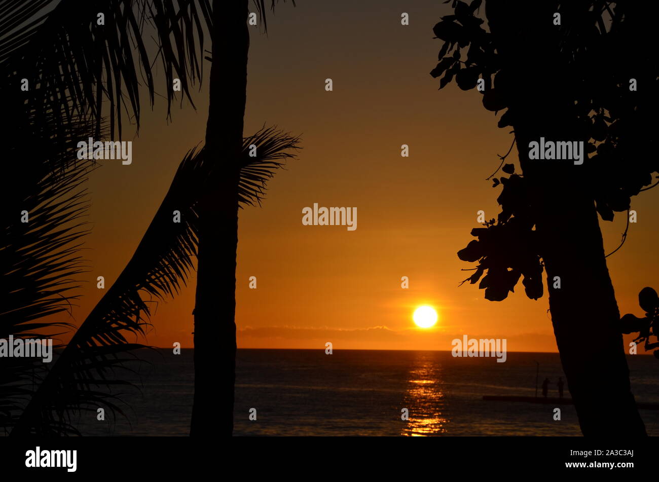Sunet over the tropical island - the view of the sea and the sun in the evening Stock Photo