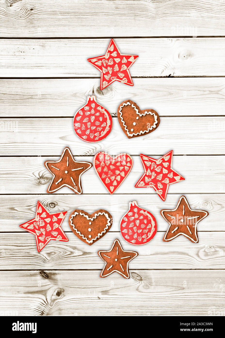 Red and white Christmas tree made of wooden rustic ornaments on white wooden planks background, greeting card Stock Photo