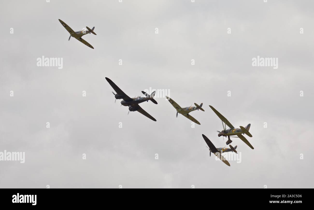 Bristol Blenheim, Westland Lysander and three Supermarine Spitfires (G-CFGJ, G-AIST, G-CGUK) flying in formation at the 2019 Flying Legends Airshow Stock Photo