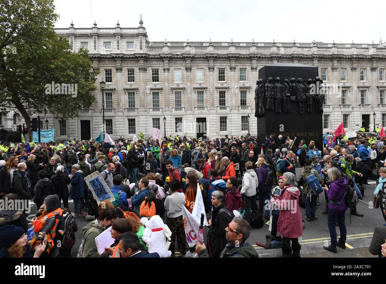 Protesters block the road during an Extinction Rebellion protest in outside the gates of Downing Street, London. Stock Photo