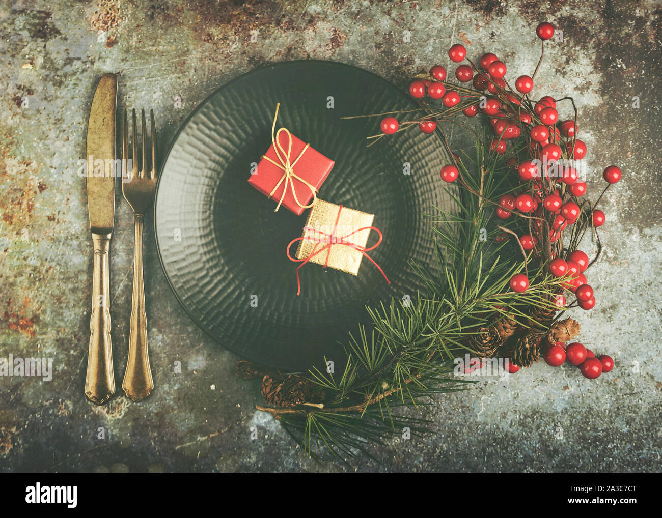 Christmas presents served on plate for Christmas Dinner with wreath on Grunge background Stock Photo