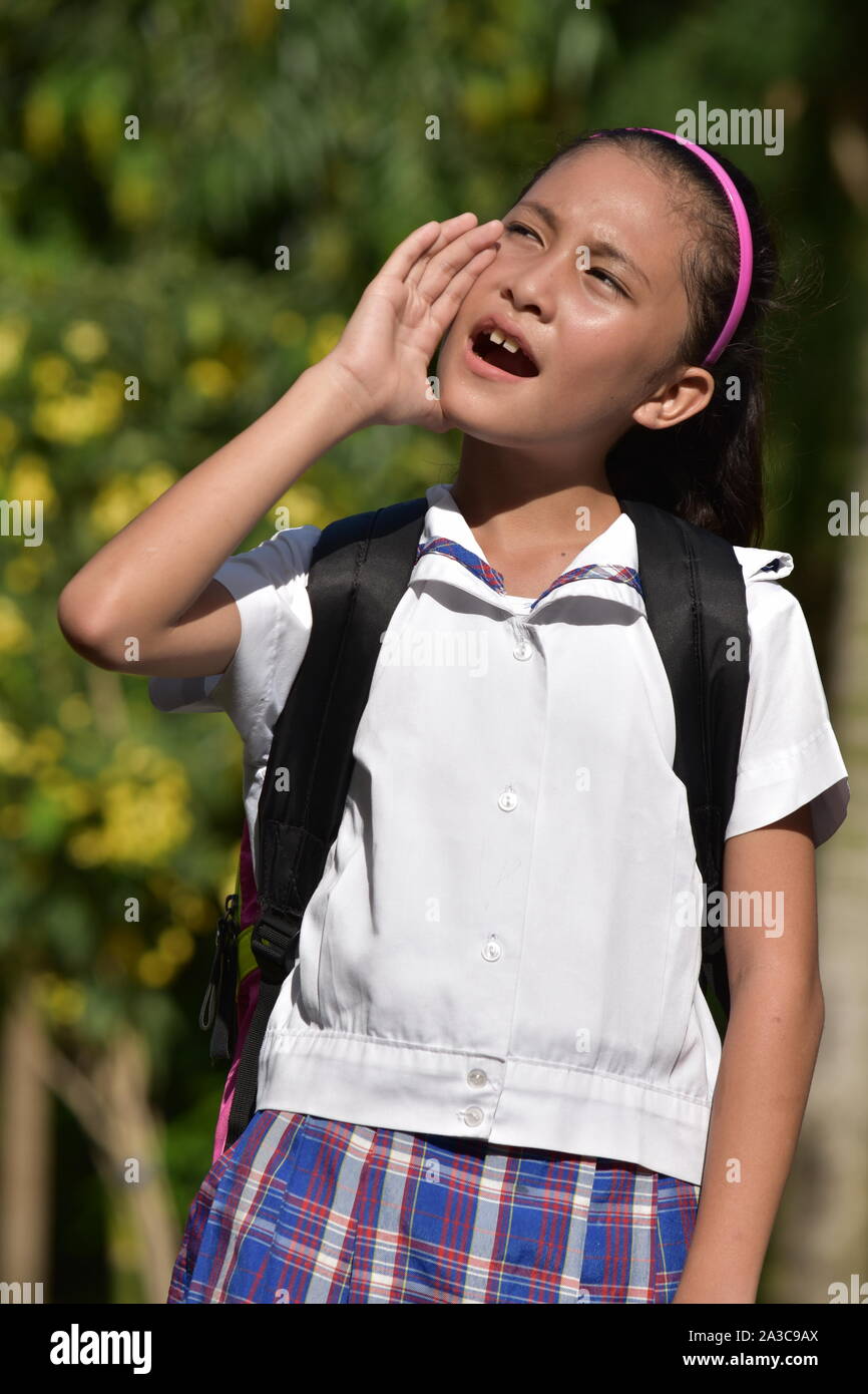Young School Girl Yelling With Books Stock Photo