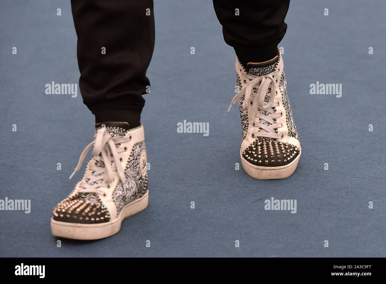 Visitors to the Frieze Masters art fair in Regent's Park, London wear arty designer trainers Stock Photo