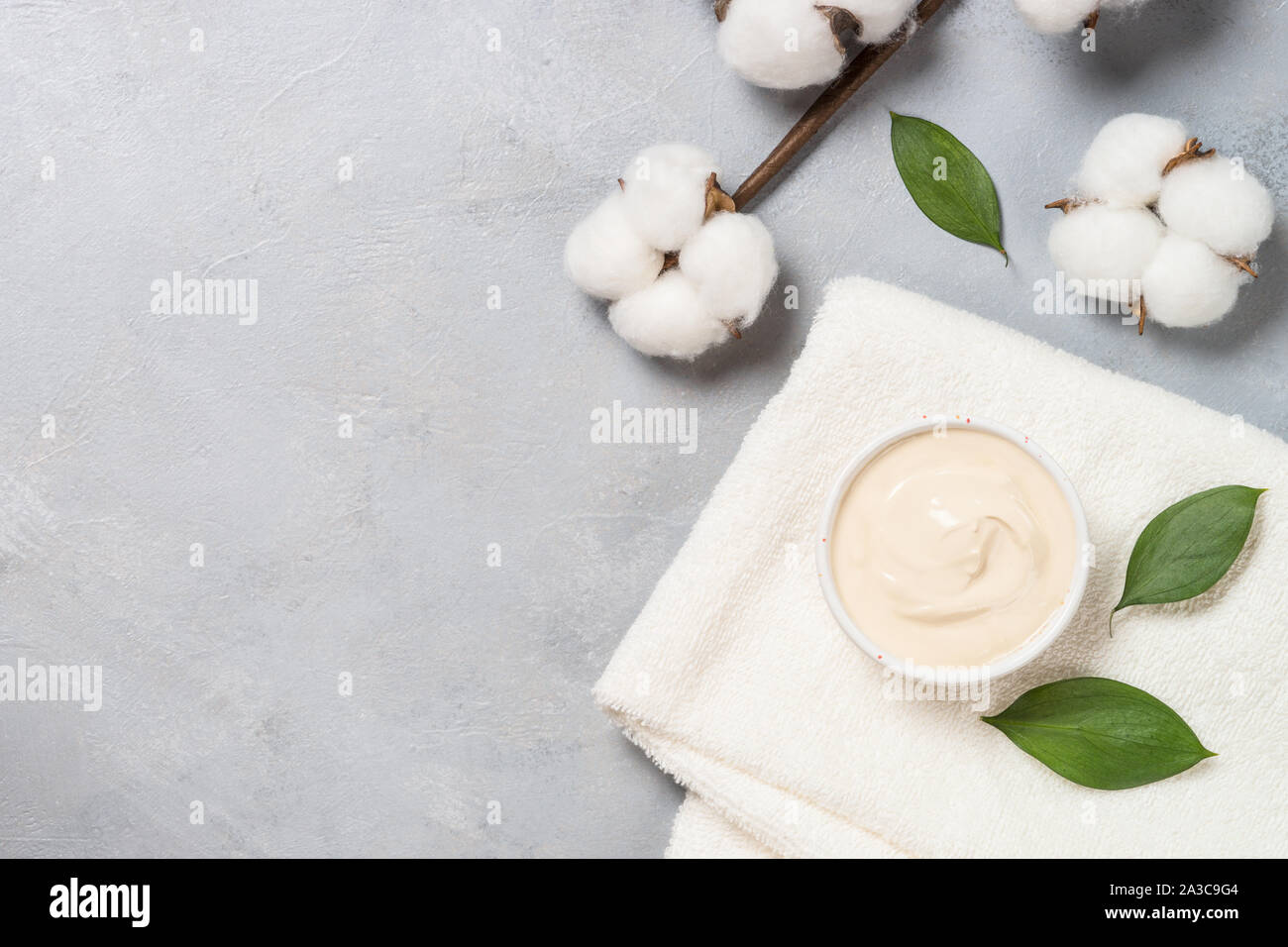 Clay mask and towel, skincare product. Stock Photo