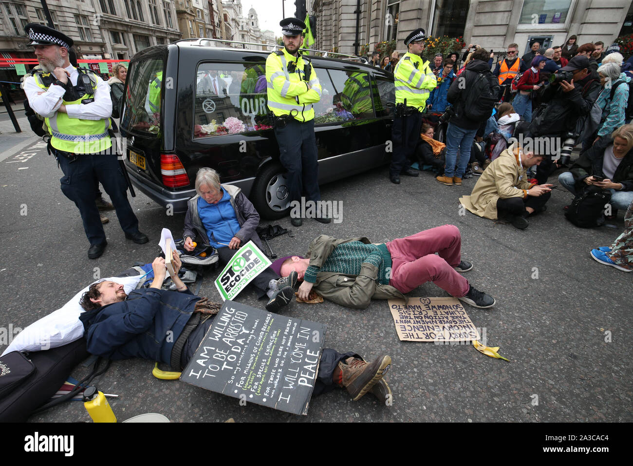 A hearse is used to block the road at the junction of Whitehall and Trafalgar Square during the Extinction Rebellion protest London. Stock Photo