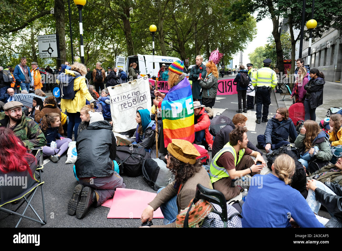Westminster, London, UK - Monday 7th October 2019 - Extinction Rebellion XR climate protesters block roads around Westminster - shown here a group of XR protesters blocking Millbank near Parliament. Photo Steven May / Alamy Live News Stock Photo