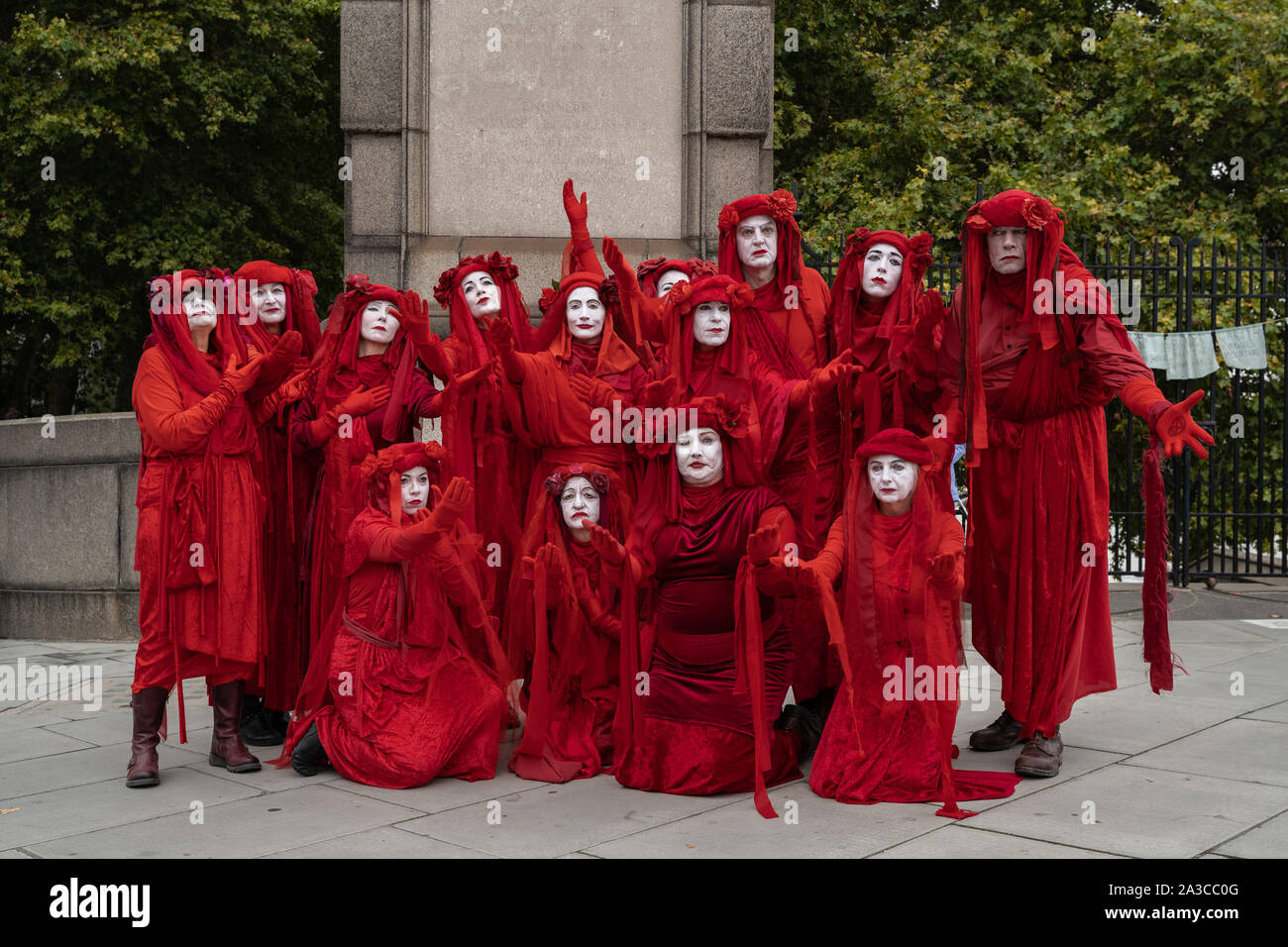Extinction Rebellion's 'Red Rebel Brigade' join the climate change activists on Lambeth Bridge wearing their trademark blood red outfits. London, UK. Stock Photo