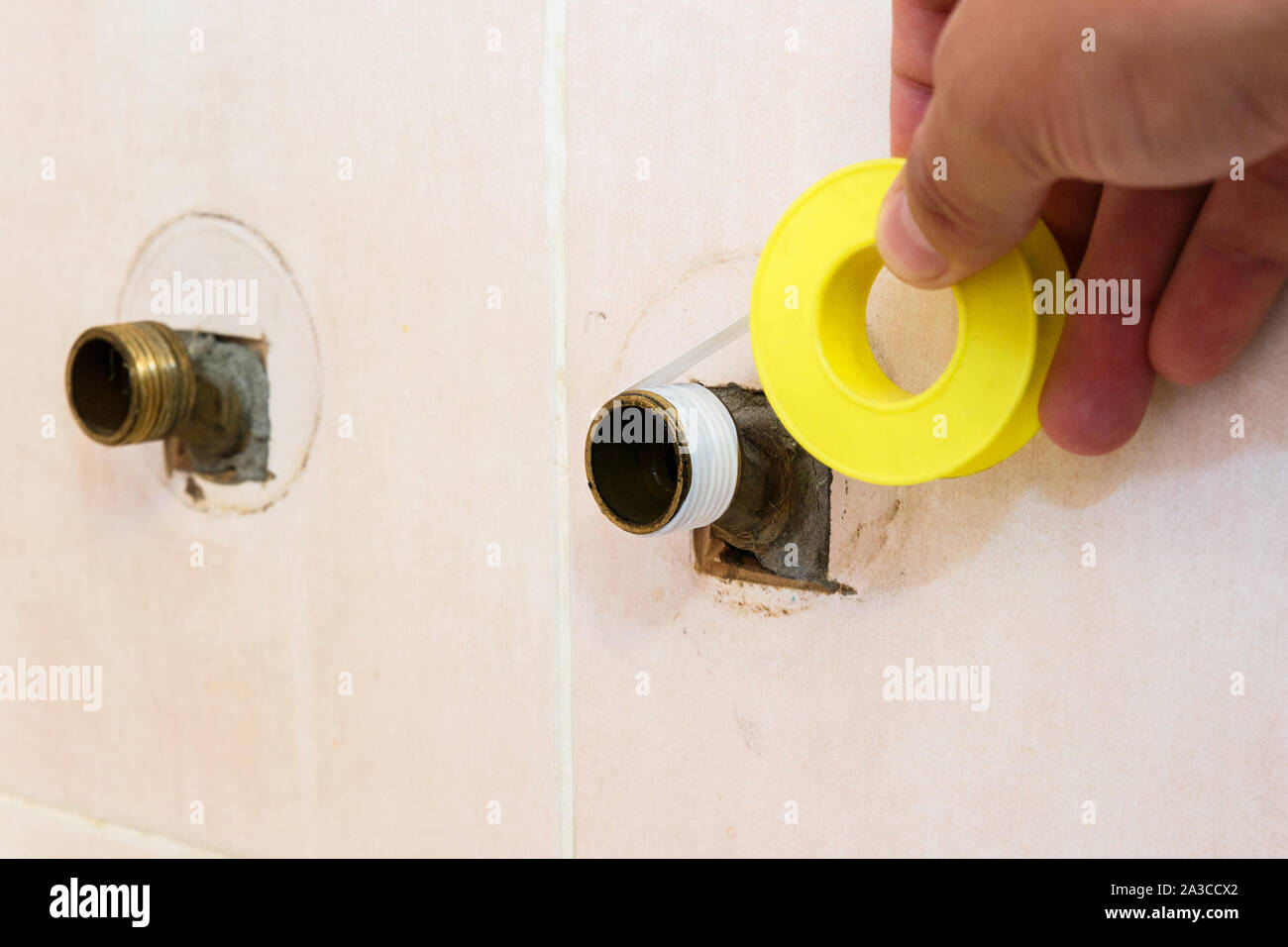 The plumber puts Teflon seam FUM tape on the thread before installing