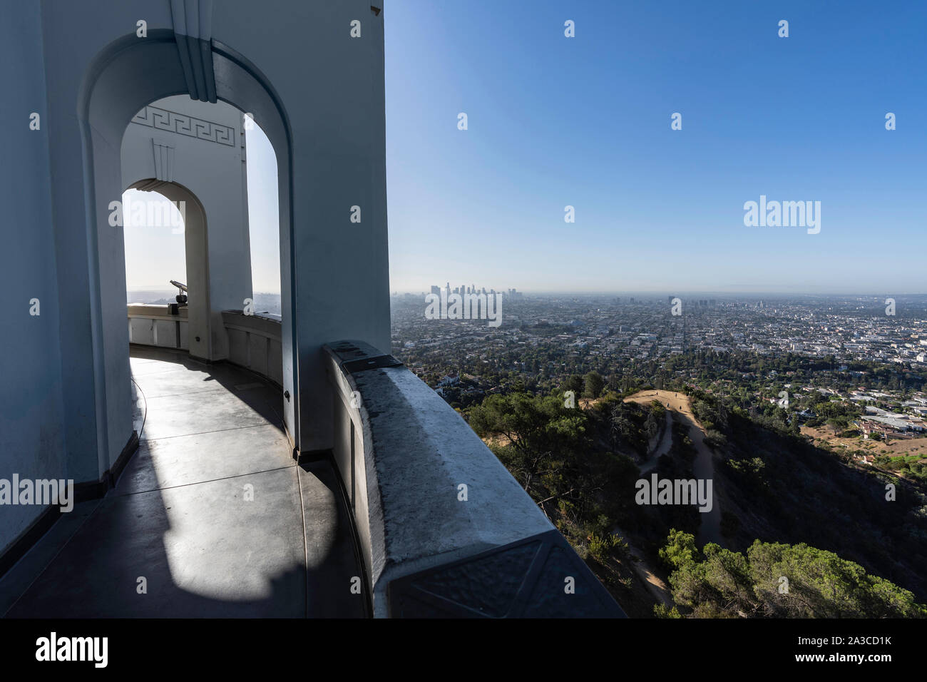 Los Angeles, California, USA - October 3, 2019:  Downtown skyline and arched walkway at the popular Griffith Park Observatory. Stock Photo