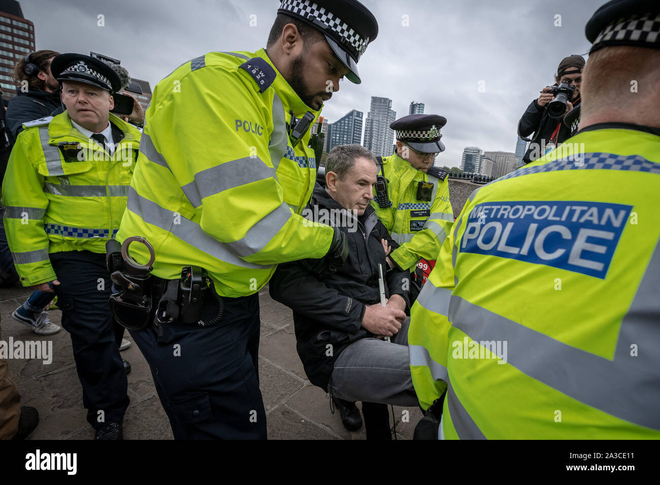 Police make an arrest of an Extinction Rebellion protester during the activist occupation of Lambeth Bridge. The environmental campaigners begin a two week new wave of protest action causing disruption at key sites in London including Westminster Bridge, Lambeth Bridge, Trafalgar Square, Parliament areas and Smithfield market as well as several road blockades. The Metropolitan Police have confirmed over 1500 arrests to date. London, UK. Stock Photo