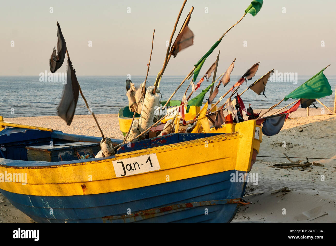 Traditional Polish fishing boats (Kutry) during a sunset on a beach near the town of Jantar, Poland. Stock Photo