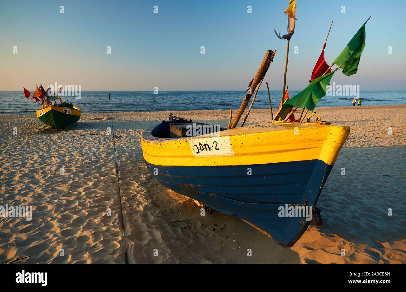Traditional Polish fishing boats (Kutry) during a sunset on a beach near the town of Jantar, Poland. Stock Photo