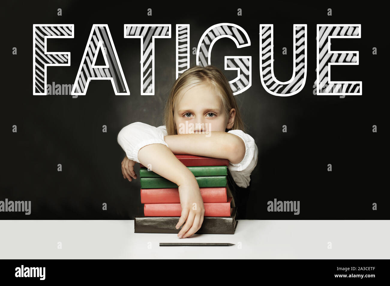 Sad Tired child with books. Fatigue concept Stock Photo