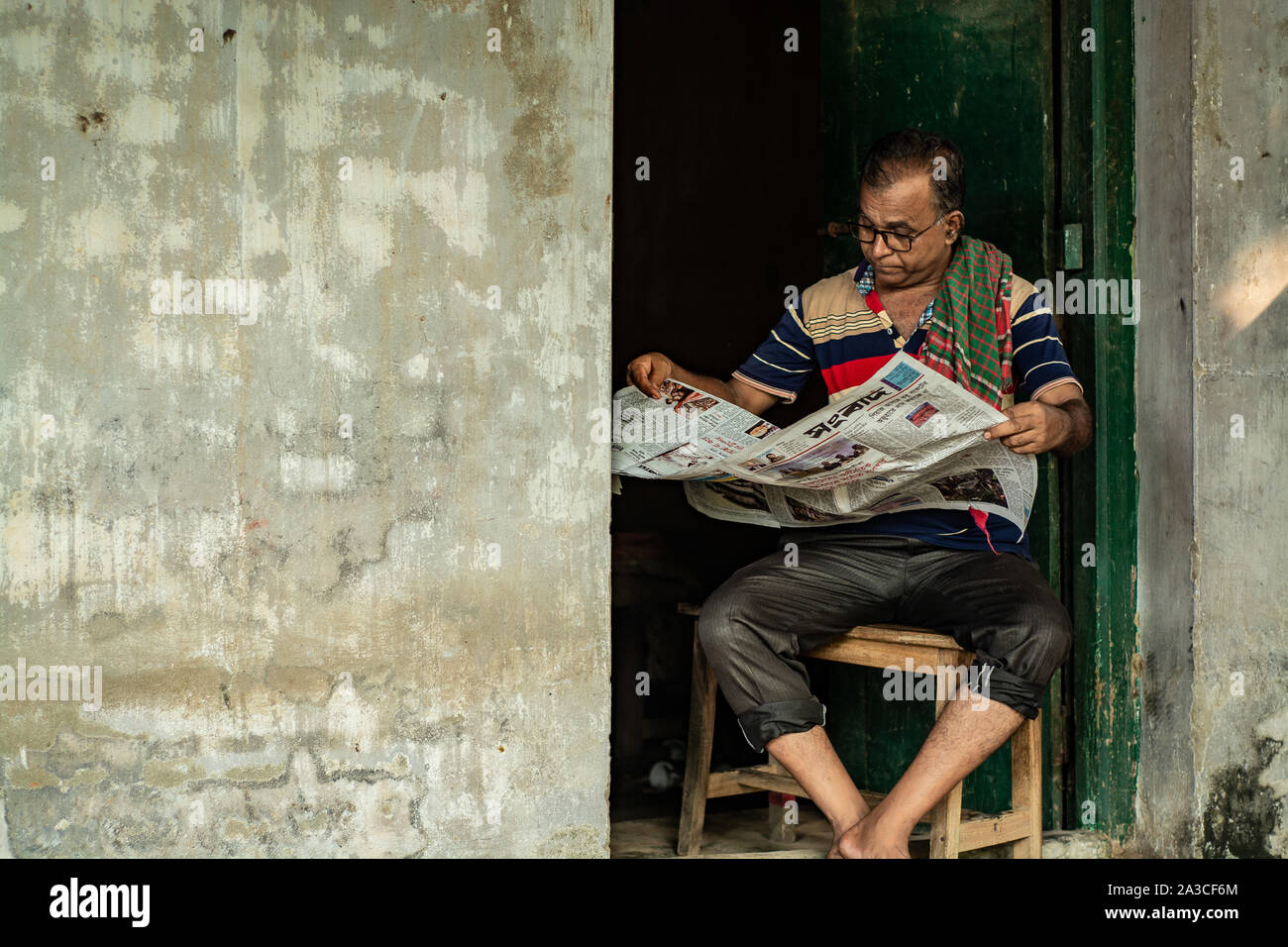 Elderly man reading newspaper in his spear time Stock Photo
