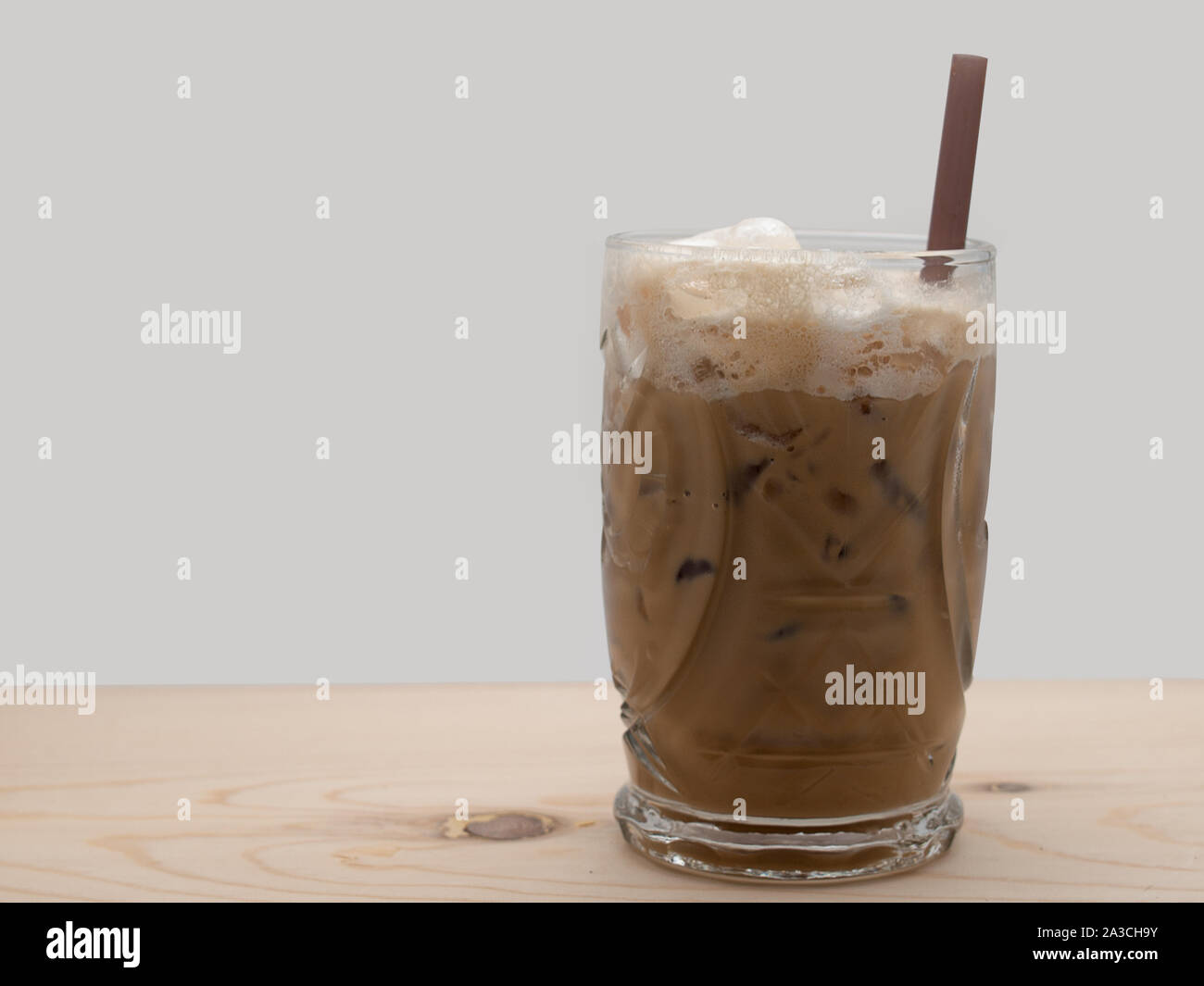 Ice coffee in glass mug with milk and cinnamon on wooden table in the  garden Stock Photo - Alamy