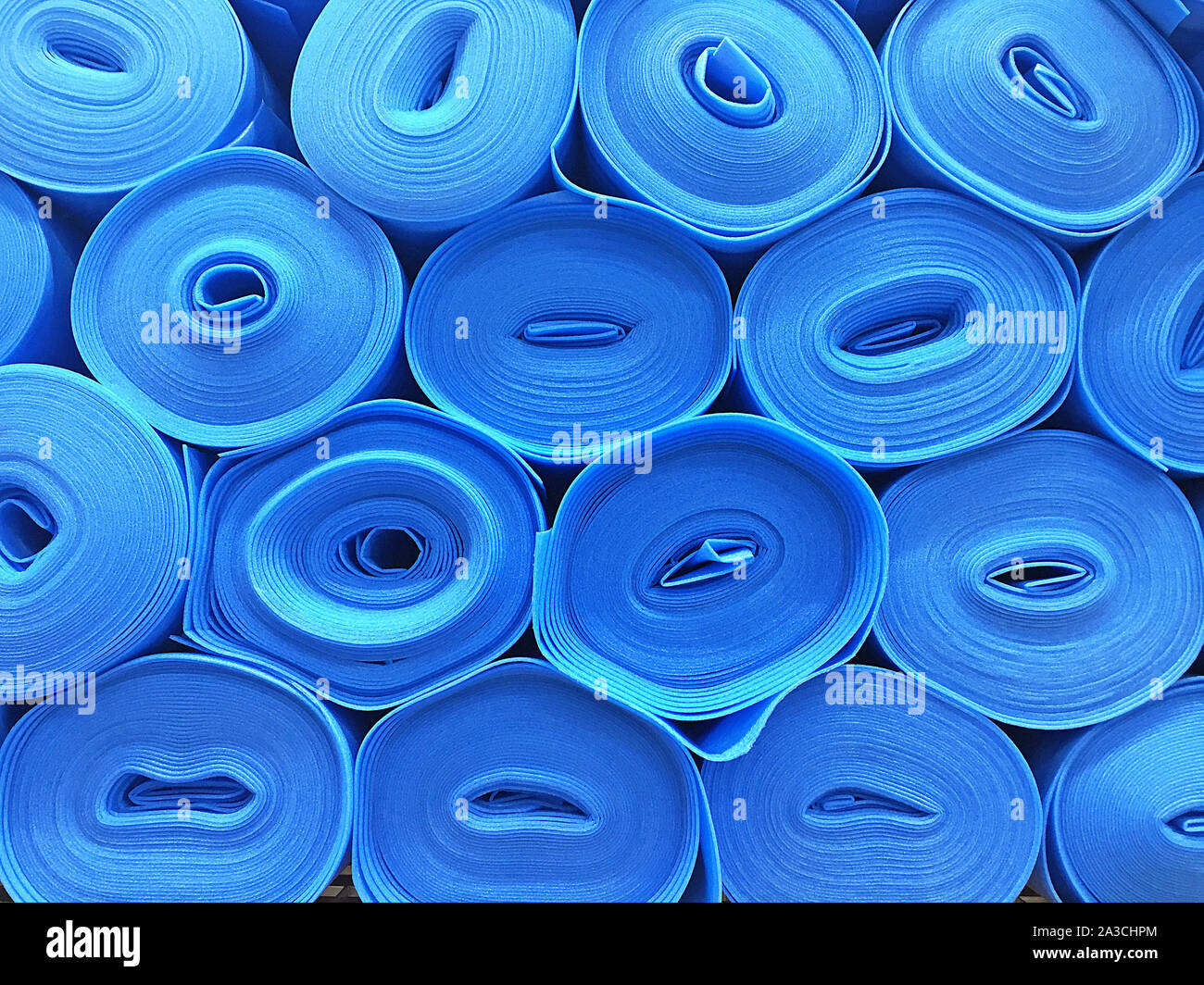 Stacked blue flooring underlay rolls Stock Photo