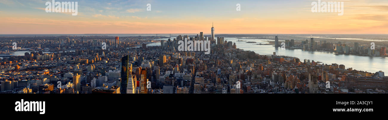 Aerial panoramic view of New York City at Sunset . Brooklyn (left), Midtown and Lower Manhattan (center) with Jersey City (right). USA Stock Photo