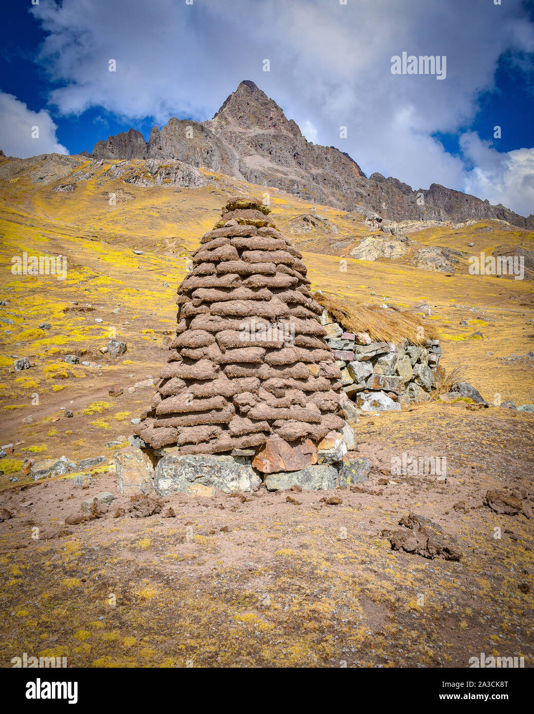 A dirt mound used for drying llama and alpaca waste for use as fuel and fertilizer in the high Andes. Ausungate, Cusco, Peru Stock Photo