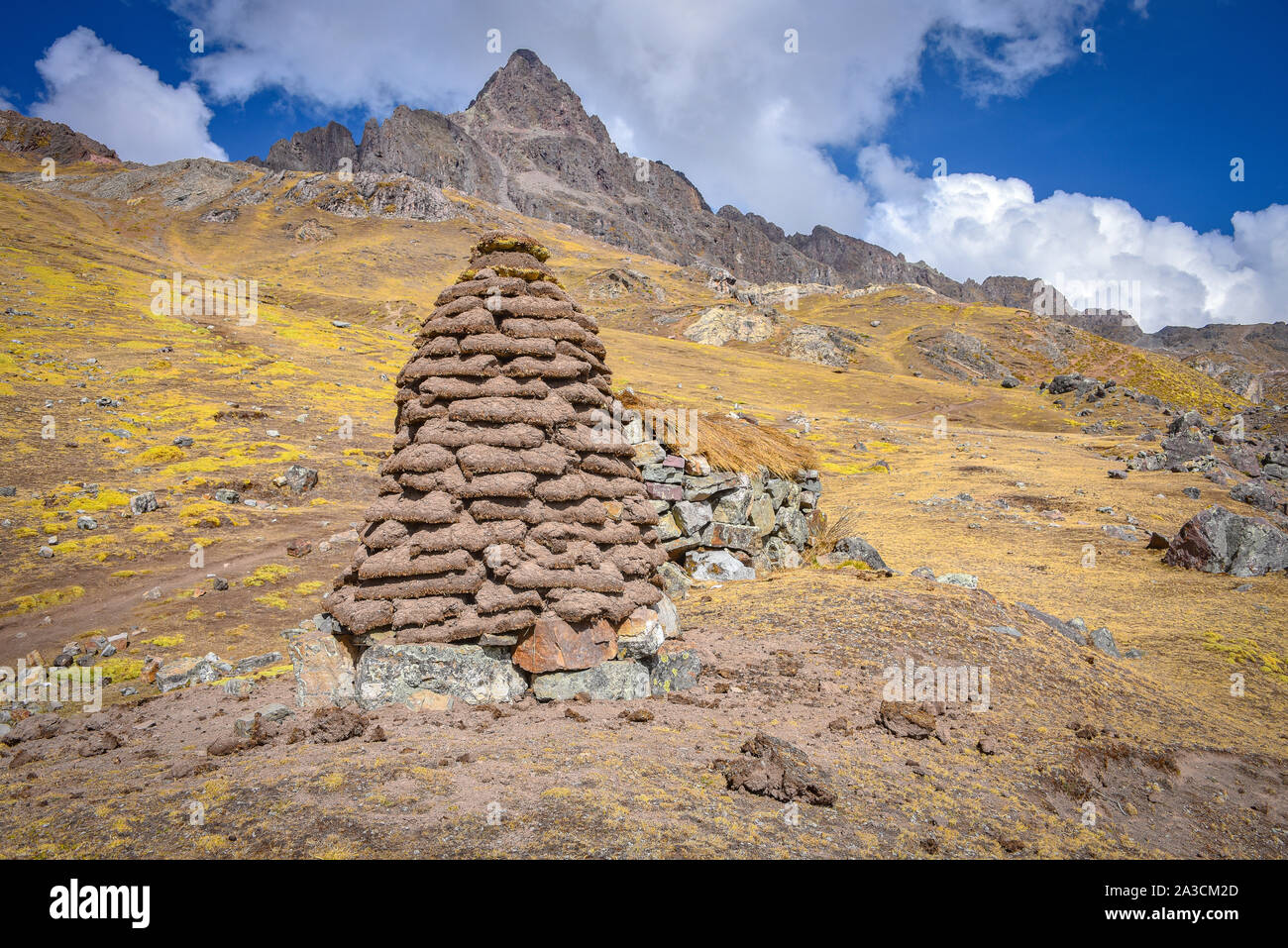 A dirt mound used for drying llama and alpaca waste for use as fuel and fertilizer in the high Andes. Ausungate, Cusco, Peru Stock Photo