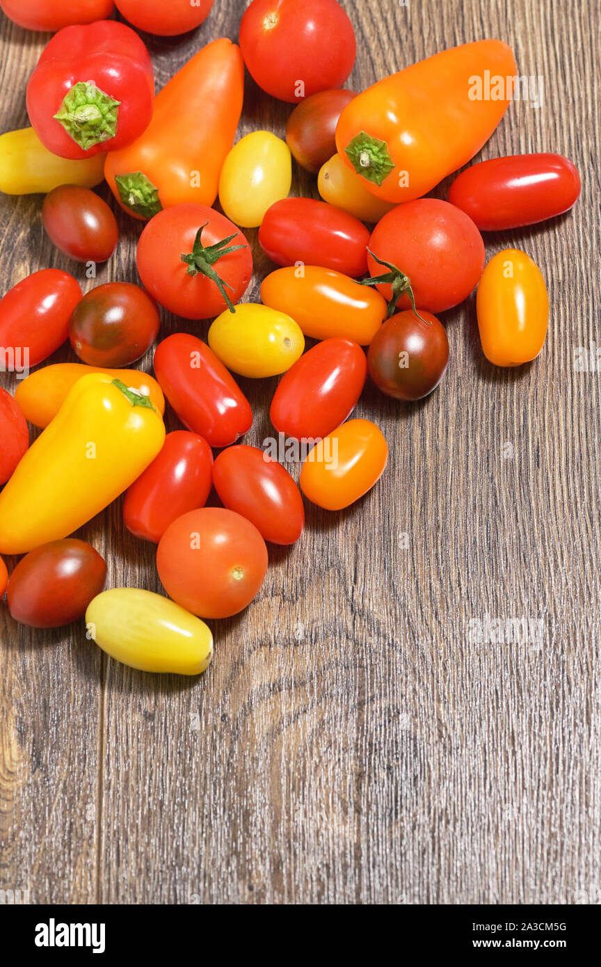 Assortment of Cherry Tomatoes and Paprika Peppers on table Stock Photo