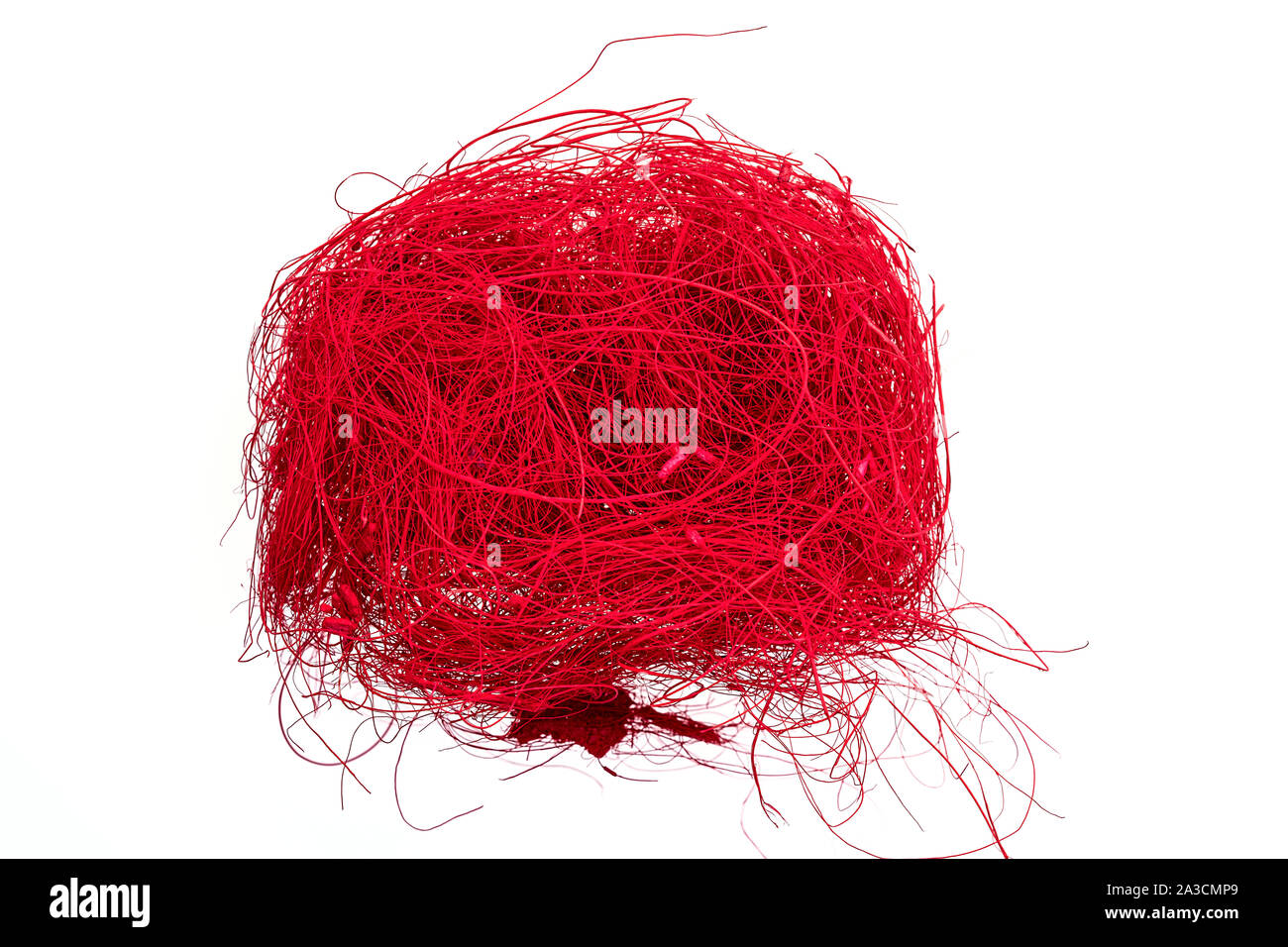 a ball of fine thin red colored intertwined flax cords Stock Photo
