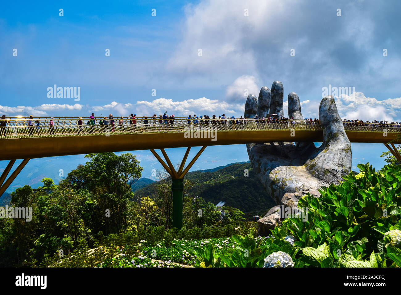 Danang, Vietnam - April 6, 2019: The Golden Bridge is lifted by two giant hands in the tourist resort on Ba Na Hill in Danang, Vietnam. Ba Na Hill mou Stock Photo