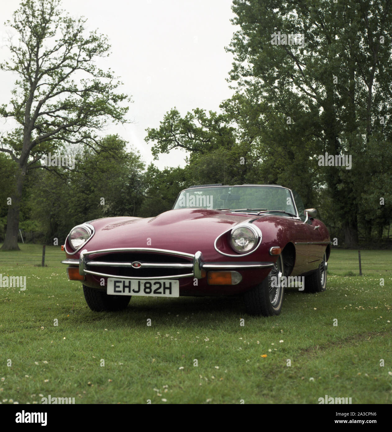 A maroon coloured E-Type Jaguar, 1969 model. Registration EHJ 82H. c1970 Photo by Tony Henshaw Archive Stock Photo