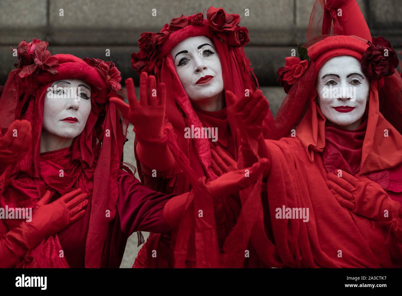 Extinction Rebellion's 'Red Rebel Brigade' join the climate change activists on Lambeth Bridge wearing their trademark blood red outfits. London, UK. Stock Photo