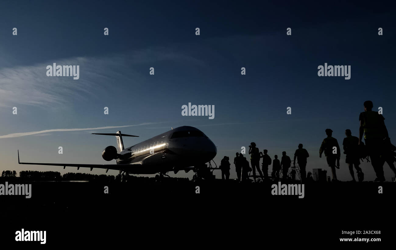 Boarding on flight on runway in airport. Silhouette of passengers ...