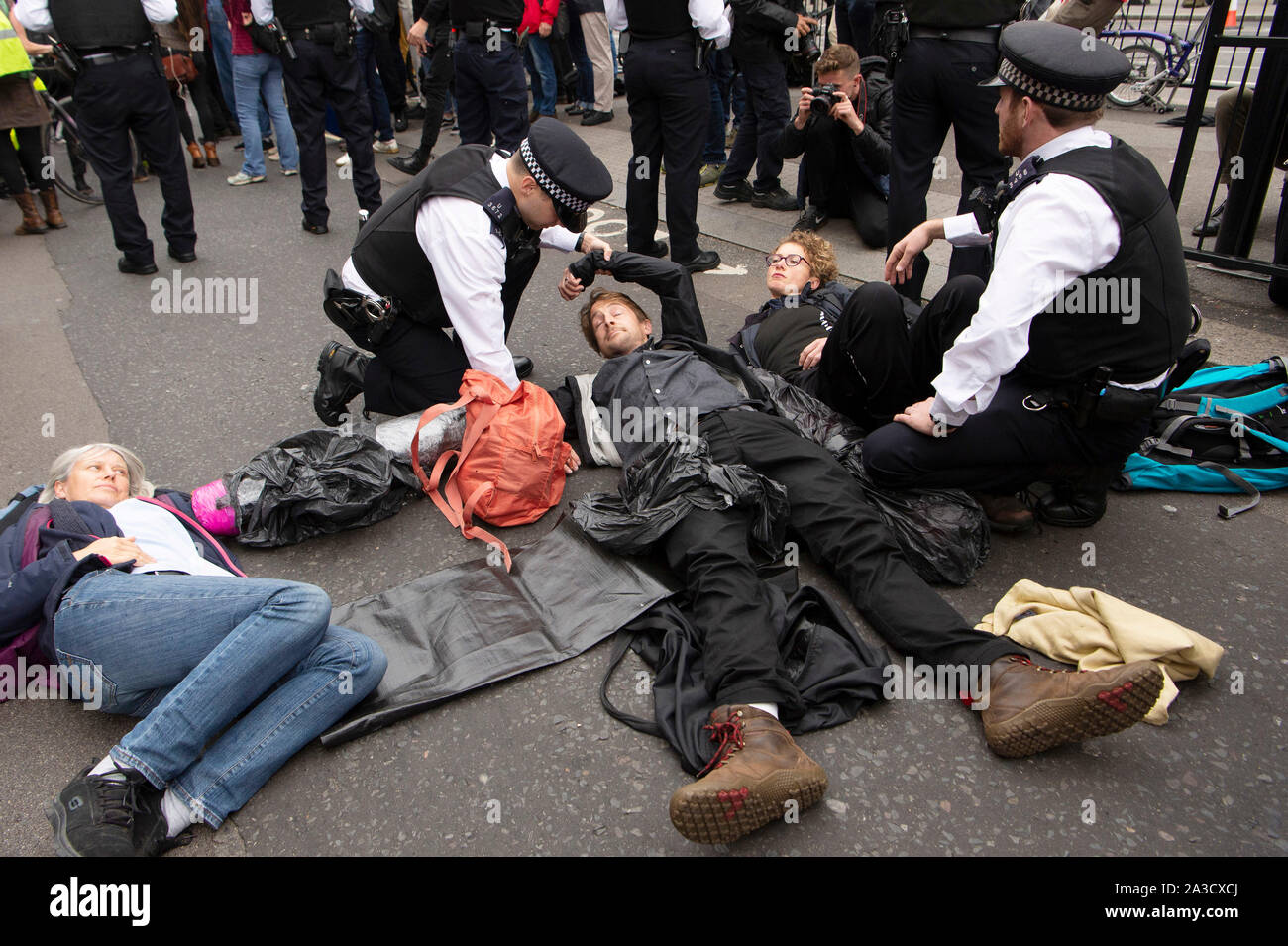 London, Britain. 7th Oct, 2019. Police officers arrest protesters in London, Britain, Oct. 7, 2019. London police confirmed 21 arrests so far in the central part of the British capital on Monday morning at the start of two weeks of protests by environmental campaigners. Credit: Ray Tang/Xinhua/Alamy Live News Stock Photo