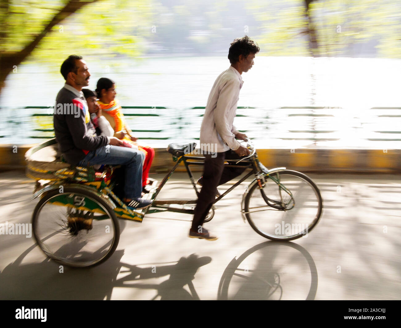 Rickshaw driver taking people for a ride around Naini Lake, Nainital, Uttarakhand, India Stock Photo