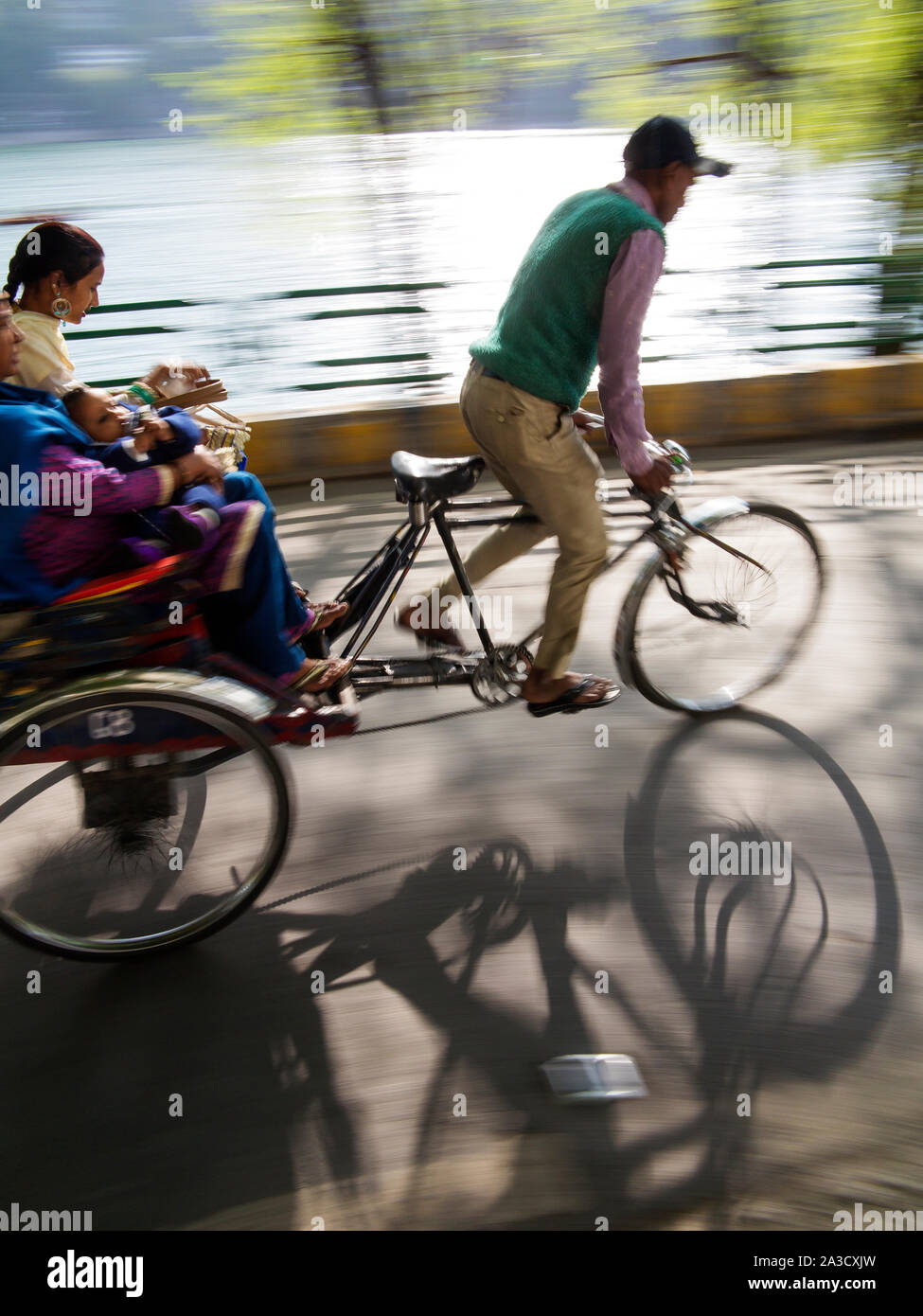 Rickshaw driver taking people for a ride around Naini Lake, Nainital, Uttarakhand, India Stock Photo