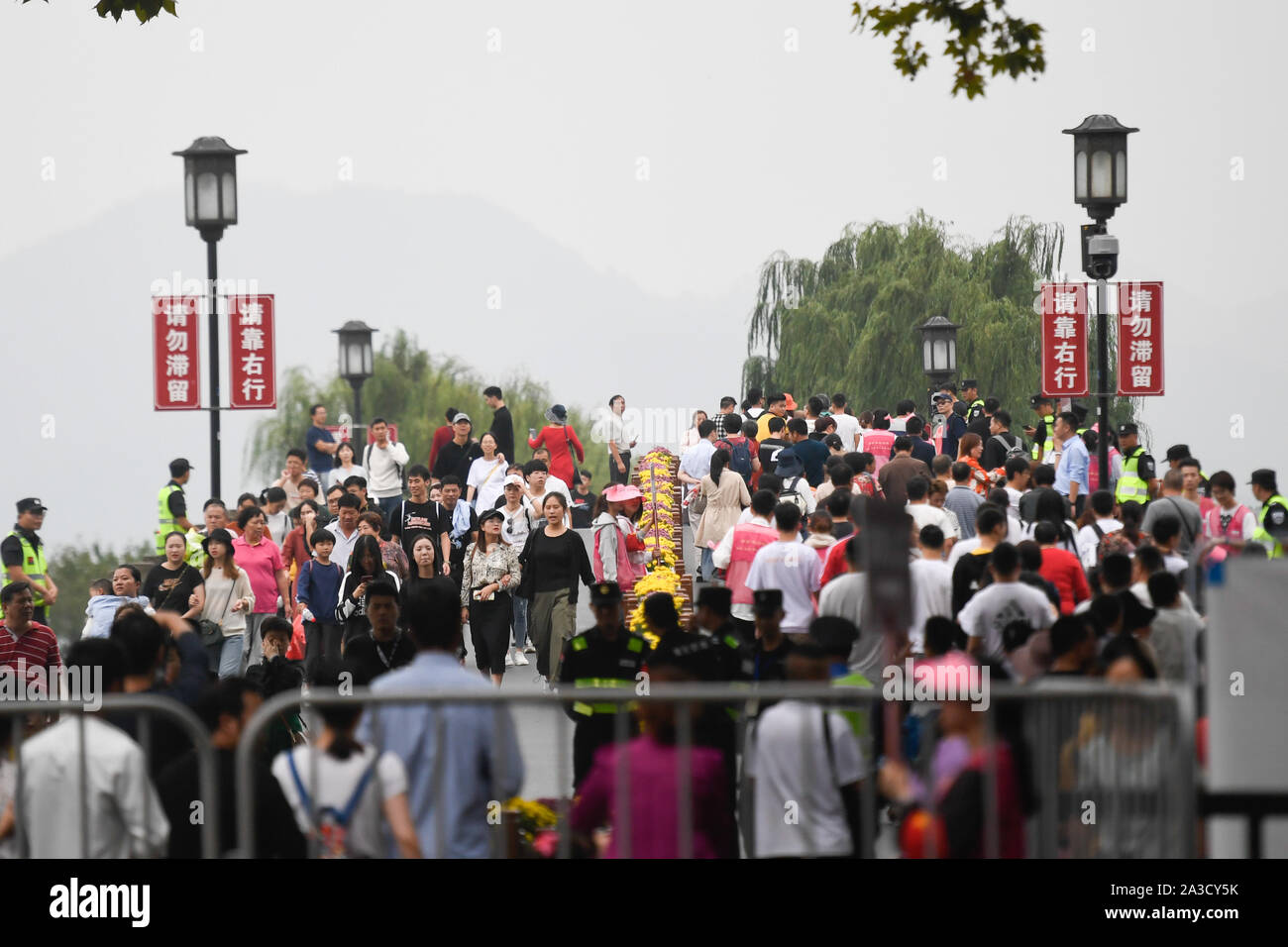 (191007) -- BEIJING, Oct. 7, 2019 (Xinhua) -- Tourists crowd the West Lake scenic area in Hangzhou, capital of Zhejiang Province, Oct. 7, 2019. According to the Ministry of Culture and Tourism (MCT), Chinese tourists made 782 million visits to recreational and cultural activities during the week-long National Day holiday, marking a year-on-year increase of 7.81 percent. China's tourism industry has raked in over 649.71 billion yuan (about 90.9 billion U.S. dollars) in revenue from domestic tourists during the holiday, up 8.47 percent from a year earlier. (Xinhua/Huang Zongzhi) Stock Photo