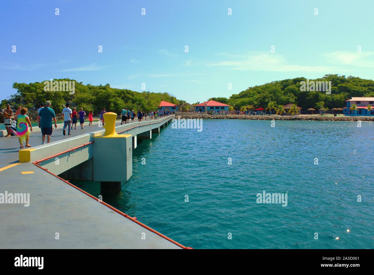 Passengers from the Royal Caribbean Anthem Of The Seas cruise ship, walk along the pier to enter the company's privately owned resort of Labadee. Stock Photo