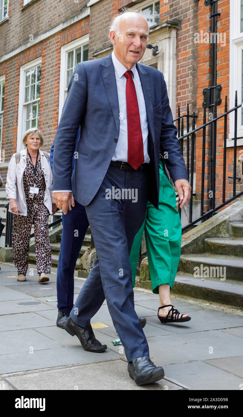 Liberal Democrat Party Leader Vince Cable, MP, on the day his predecessor and new Libdem leader is announced, walks in Westminster, London, UK Stock Photo