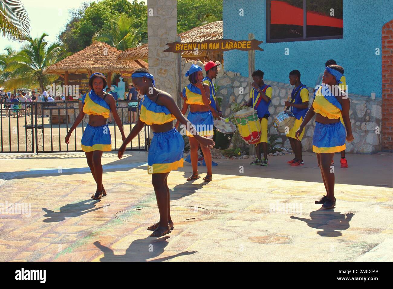 A group of traditional young dancers and drummers, performing outside the entrance to the private resort of Labadee, owned by Royal Caribbean cruises. Stock Photo