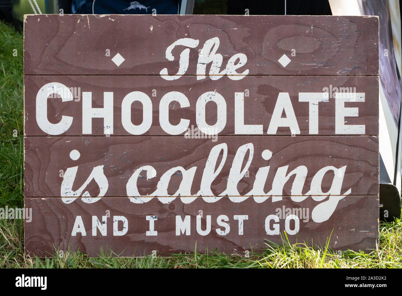 The Chocolate is calling and I must go - amusing sign Stock Photo