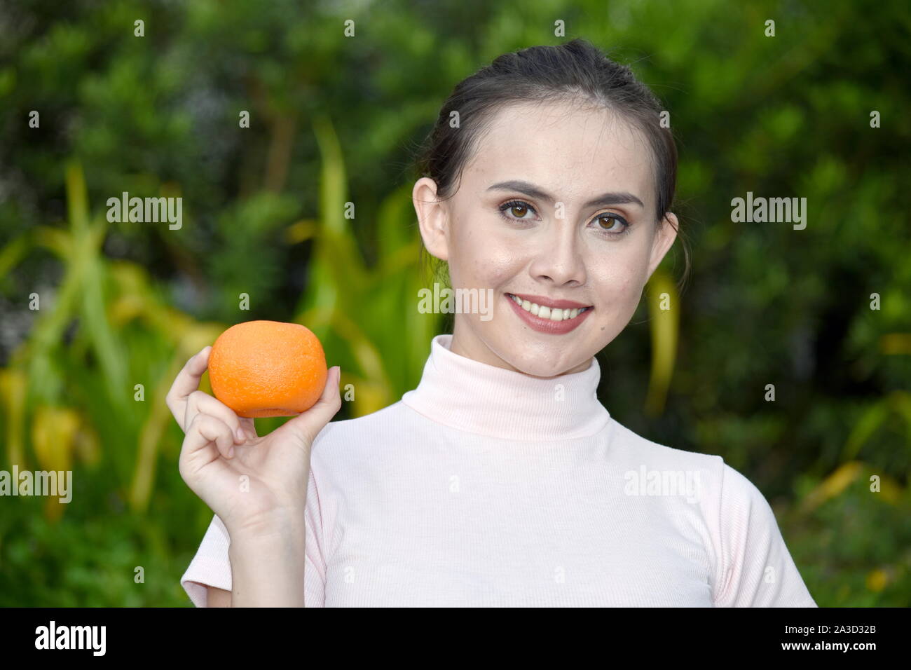 A Happy Young Female With Oranges Stock Photo