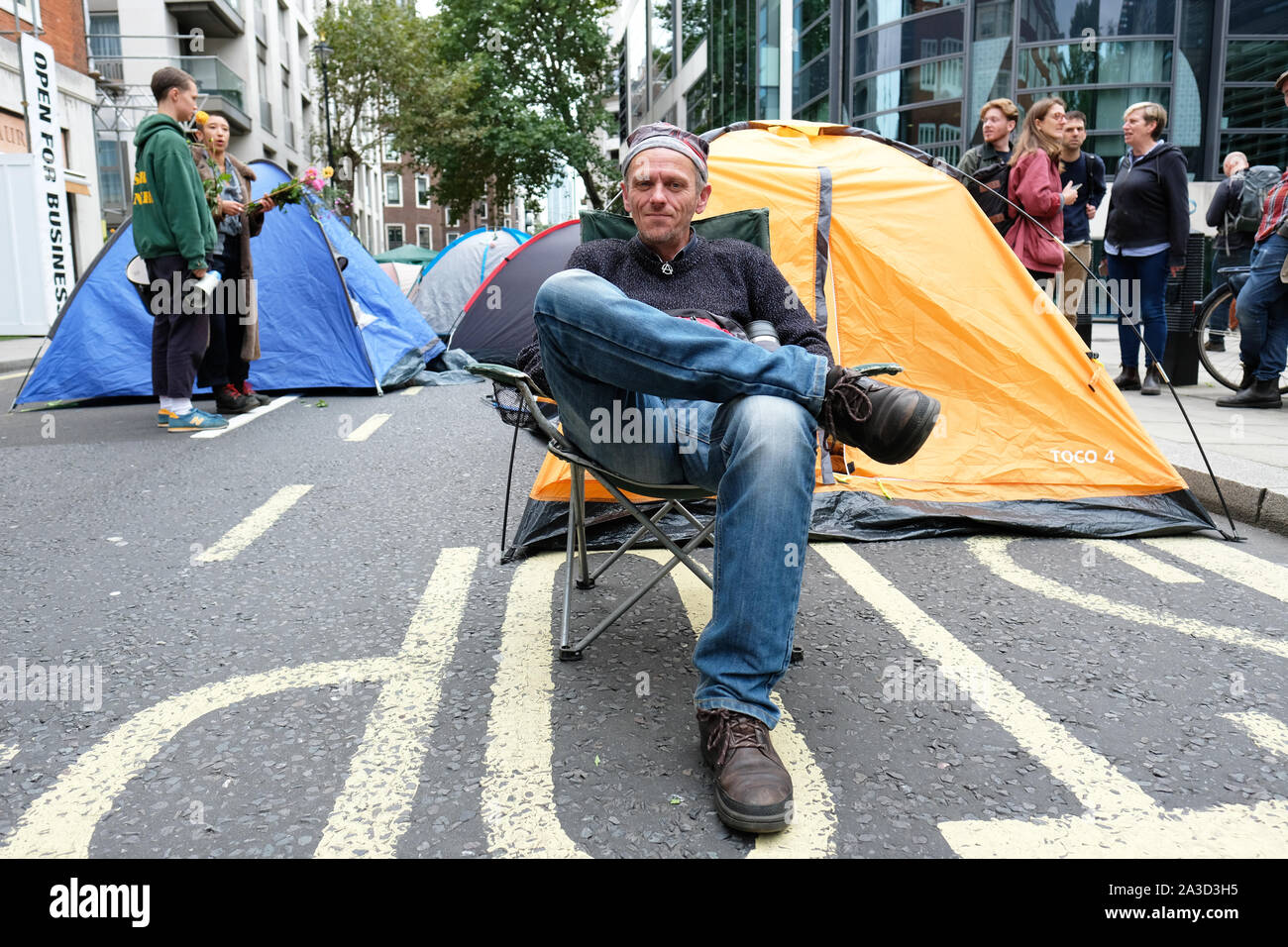 Westminster, London, UK - Monday 7th October 2019 - Extinction Rebellion XR climate protesters block Marsham Street directly outside the Home Office - some protesters have sent up tent base camps in the middle of Marsham Street.  Photo Steven May / Alamy Live News Stock Photo