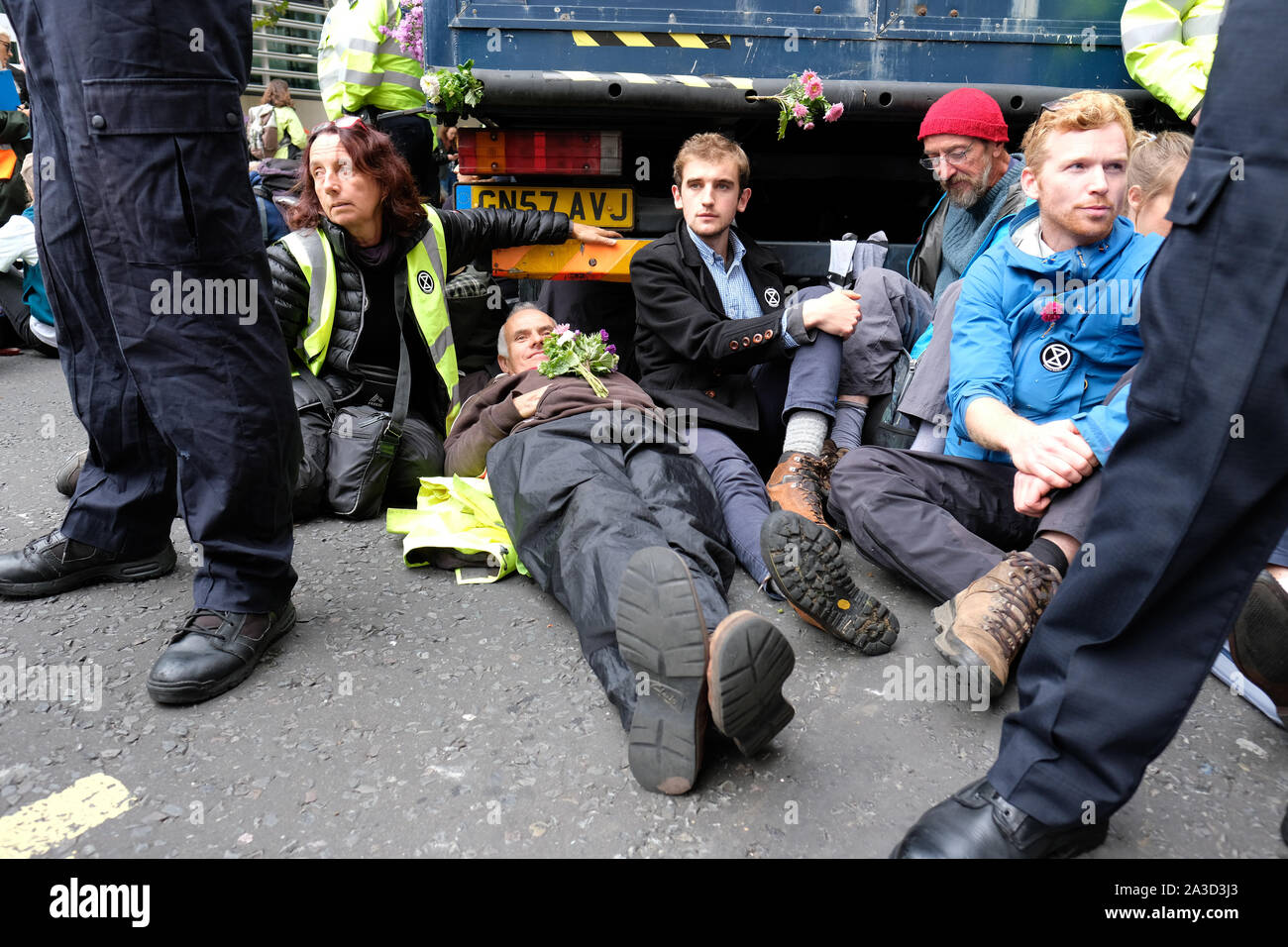 Westminster, London, UK - Monday 7th October 2019 - Extinction Rebellion XR climate protesters block Marsham Street directly outside the Home Office - some protesters have locked themselves to the underside of a lorry directly outside the Home Office building. Police stand in front of them. Photo Steven May / Alamy Live News Stock Photo