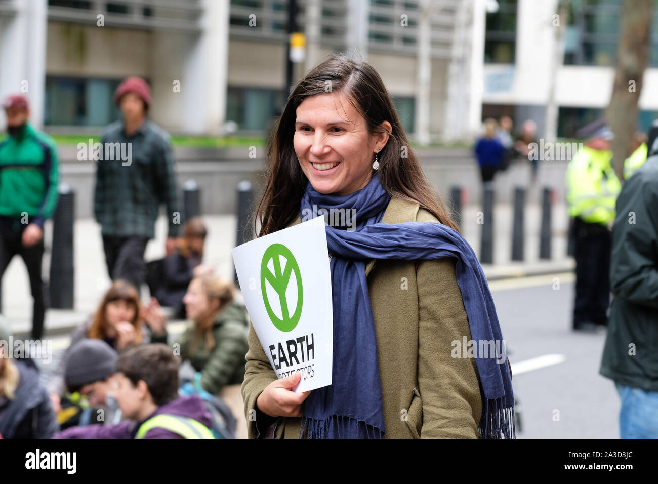 Westminster, London, UK - Monday 7th October 2019 - A female Extinction Rebellion XR climate protester among the crowd of activists blocking Marsham Street directly outisde the Home Office. Photo Steven May / Alamy Live News Stock Photo